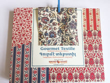 Load image into Gallery viewer, Handmade milk chocolate squares with Armenian traditional textile patterns with a fabric swatch and matching clothes pin
