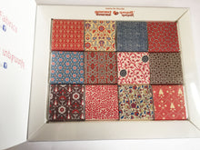 Load image into Gallery viewer, Handmade milk chocolate squares with Armenian traditional textile patterns with a fabric swatch and matching clothes pin
